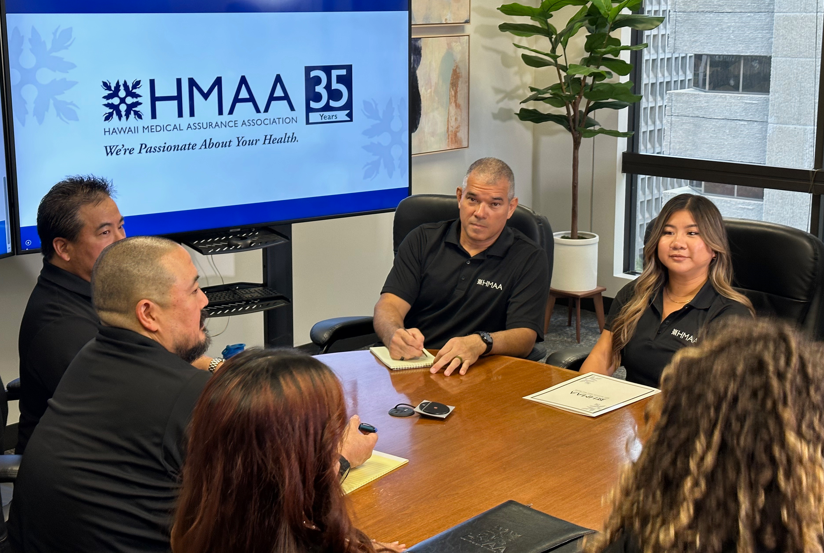 HMAA Hawaii insurance sales team strategizing how to serve business clients with small vs large group health plans