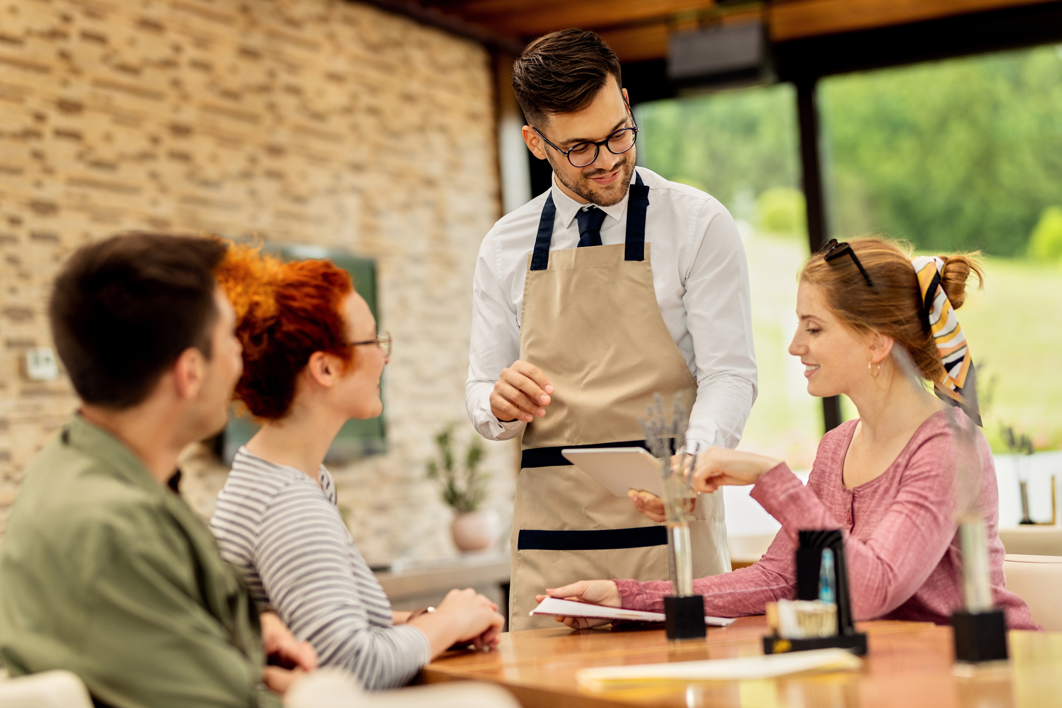 Restaurant kitchen staff preparing food together and smiling | Health insurance for restaurant workers