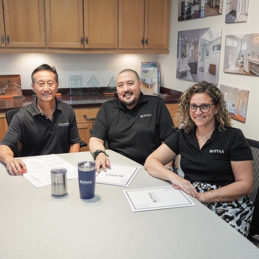 Coffee shop owners meeting with advisor in a café | Group health insurance for small business owners
